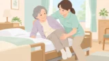 介護士が高齢者の肩と膝を支えて起き上がりを介助するイラスト